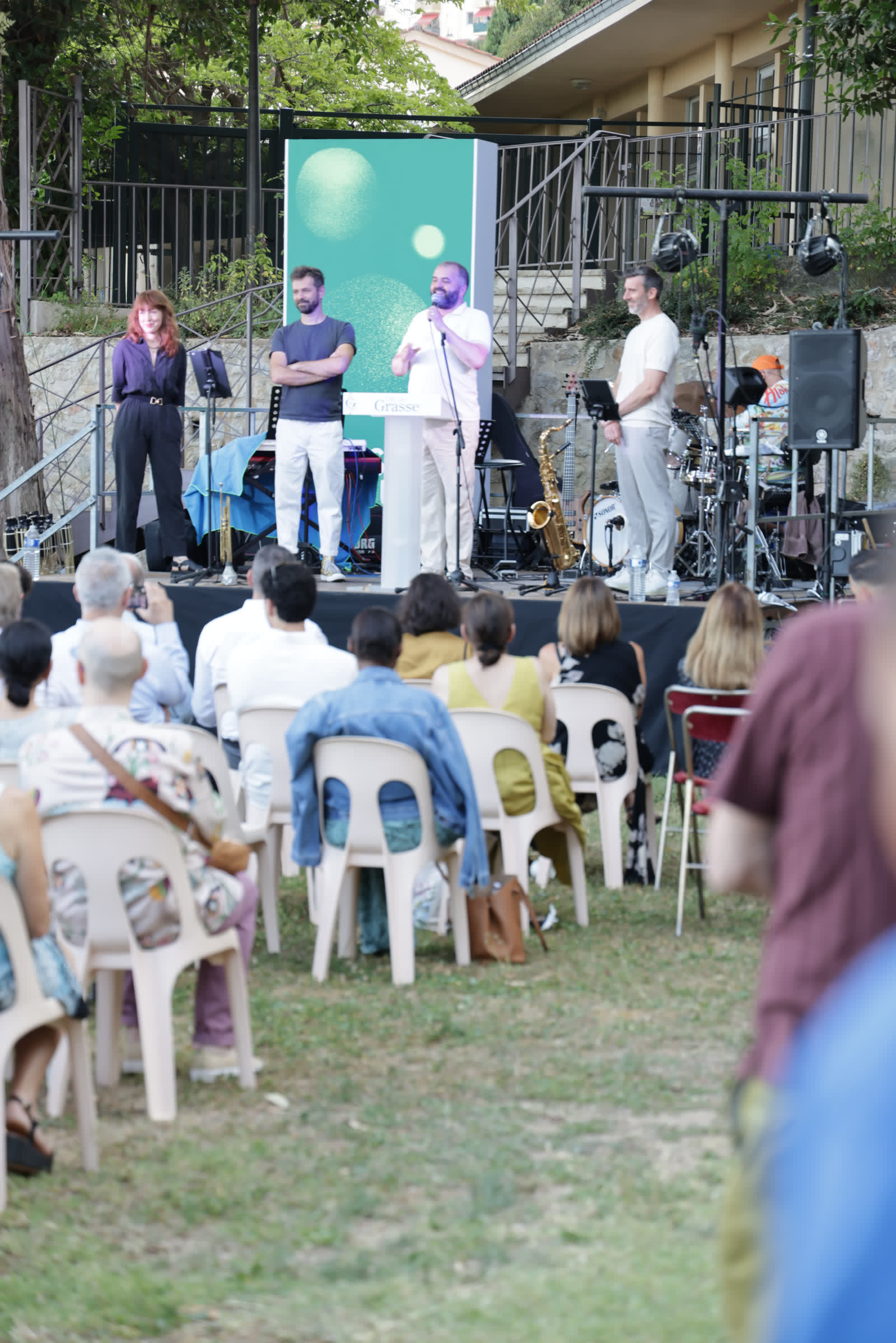 The Grasse Perfume Week stage, four presenters before a seated audience